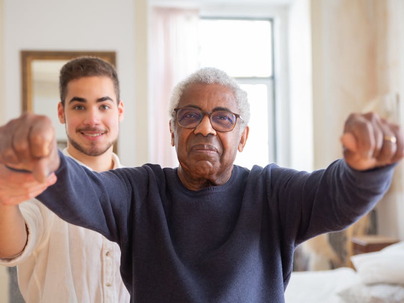 Licensed therapist helping a senior with physical therapy exercises